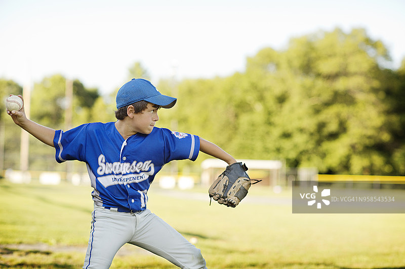 在天空背景下投球的棒球运动员图片素材