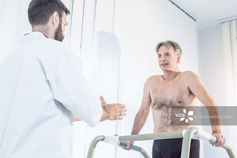 医生帮助术后年长患者走路图片素材