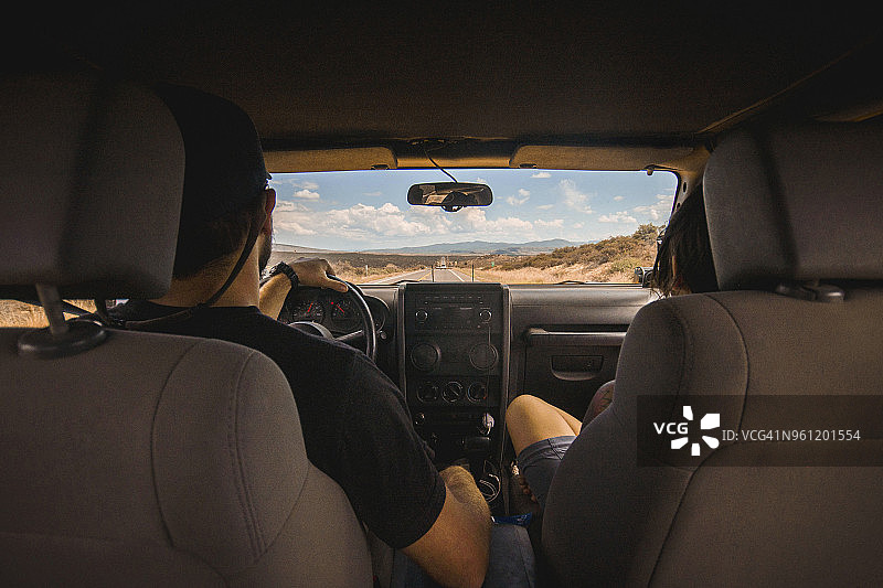 男人和女人乘坐越野车在路上旅行的背影图片素材