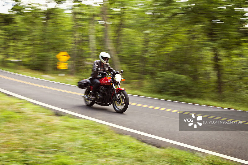 男人骑摩托车在路上图片素材