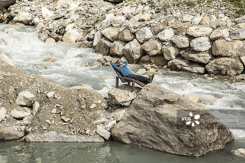 年长的男人在伊泽尔河中央的躺椅上休息图片素材