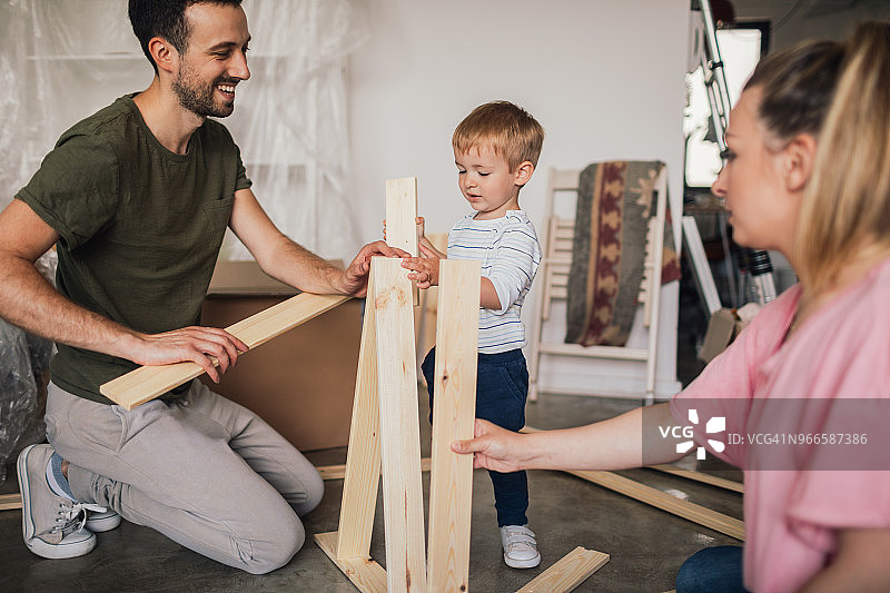 年轻家庭一起组装家具图片素材