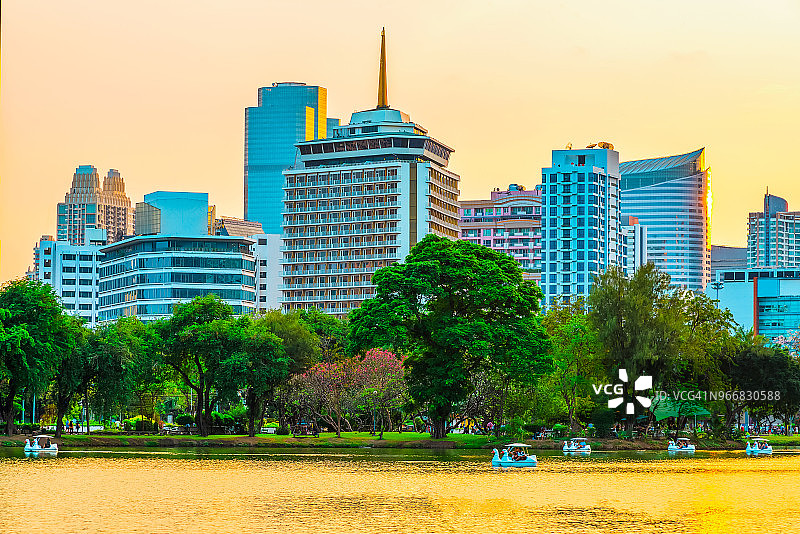 曼谷日落城市景观：伦披尼公园的湖泊和树木图片素材