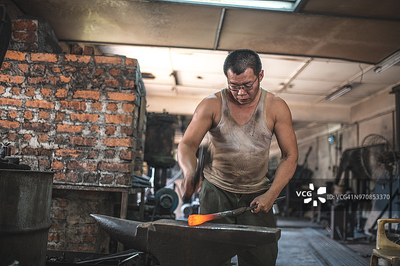 铁匠在铁砧上锻造金属图片素材