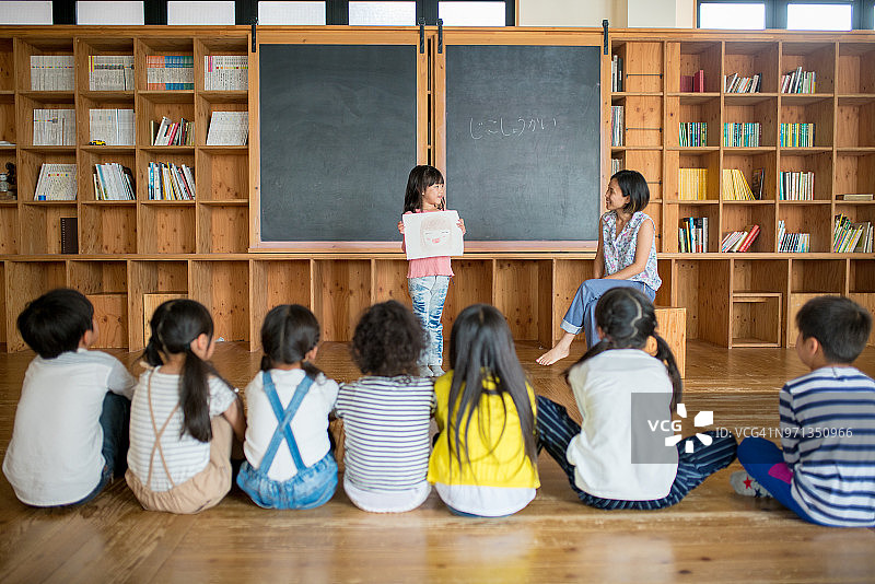 年轻女学生在课堂上做演示图片素材
