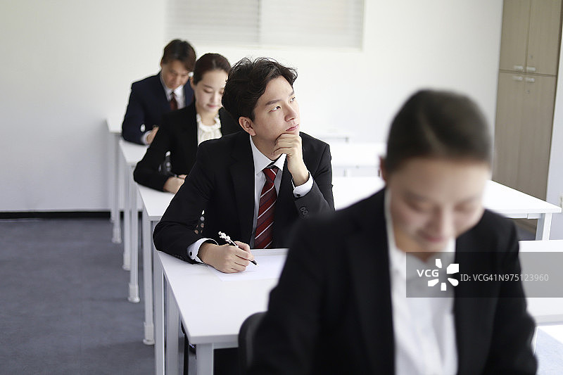 在考场中沉思的商人图片素材