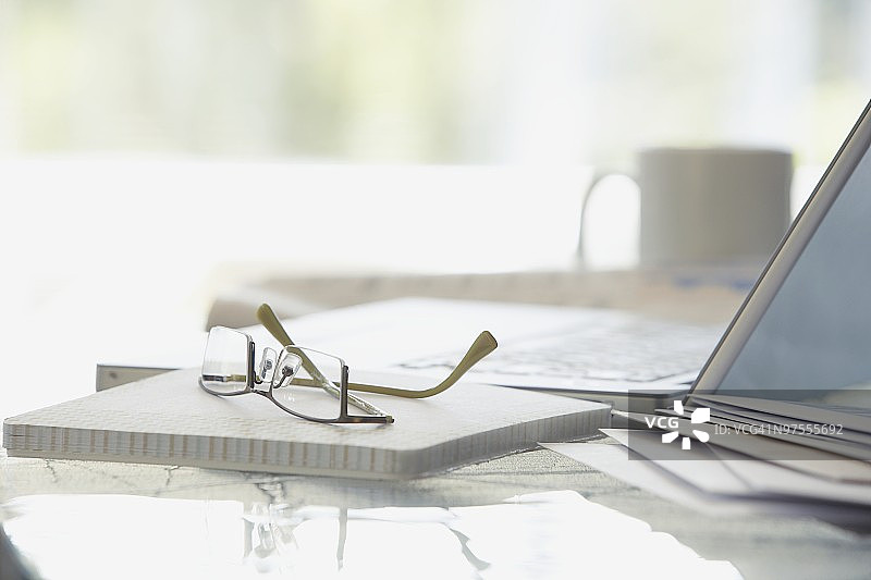 笔记本电脑旁边的眼镜图片素材