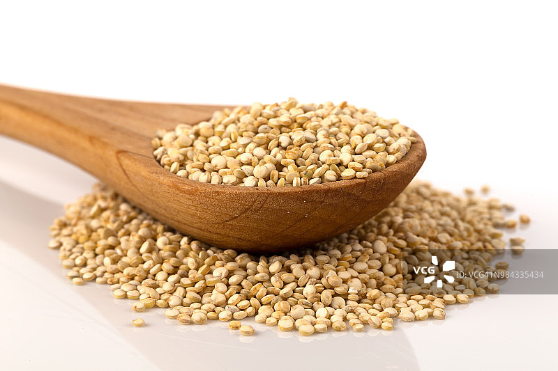 白色背景勺子里的藜麦种子堆图片素材