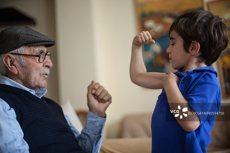 孙子向曾祖父展示肱二头肌图片素材