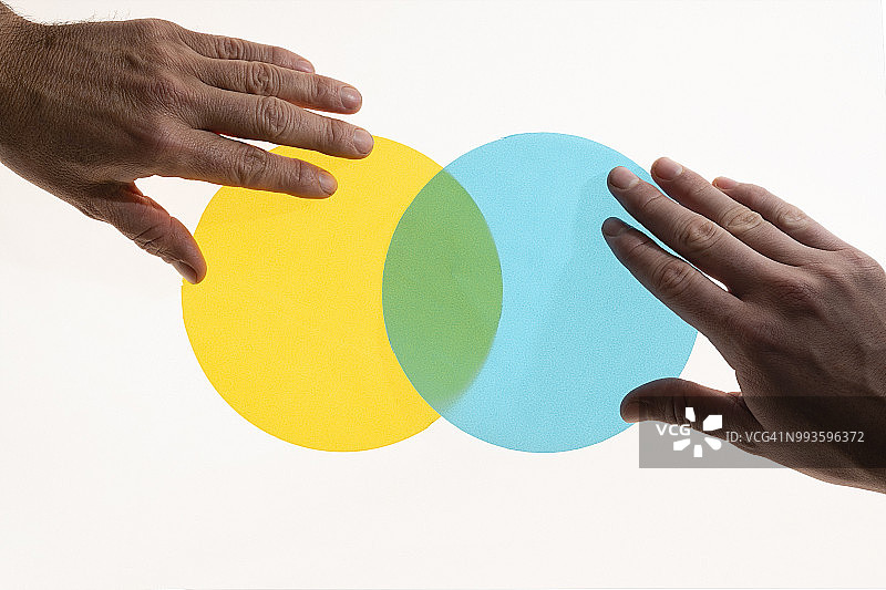 双手放置半透明圆圈形成维恩图图片素材