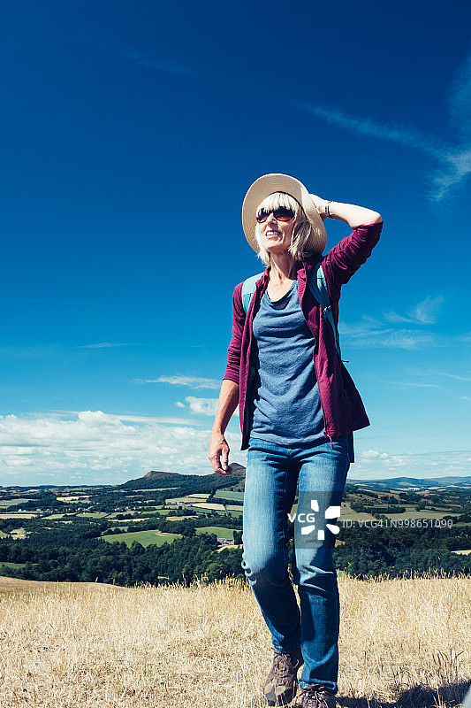 在草地上行走的活力老年妇女图片素材