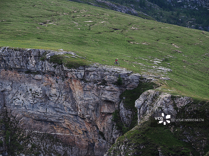 在泰吉奥罗山的陡峭山脊上进行摩托车越野的男人图片素材
