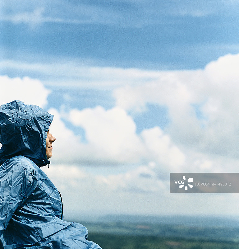 穿着连帽外套坐在乡村的男人图片素材