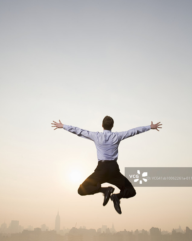商务人士在纽约市背景下跳跃图片素材
