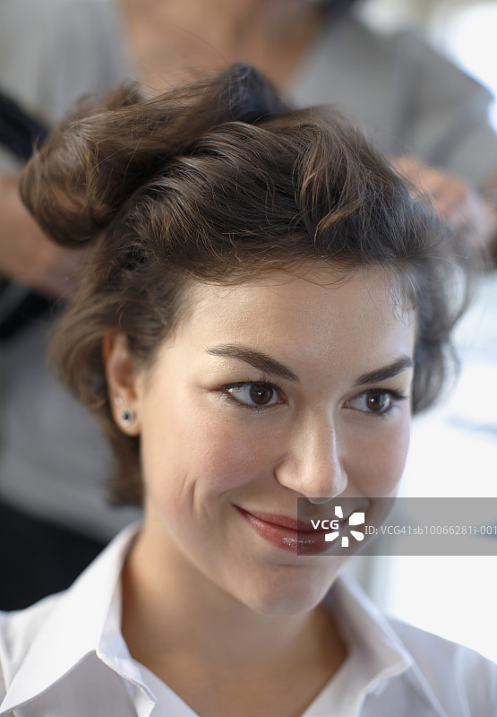 年轻女子做头发，特写图片素材