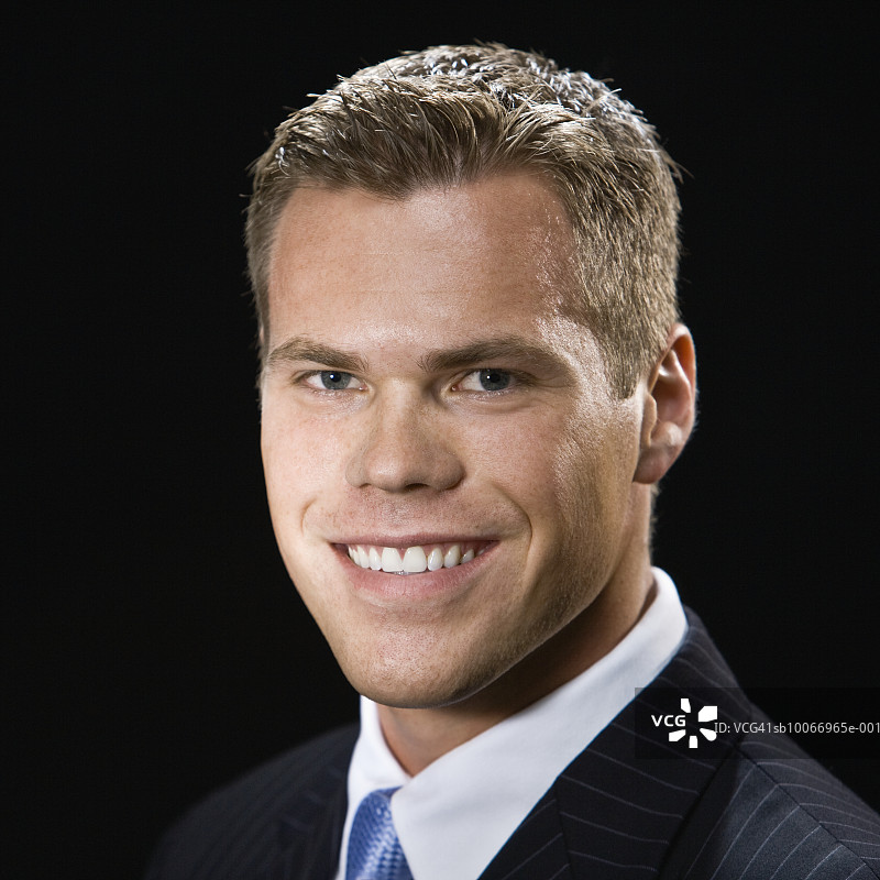 以黑色为背景的年轻男商人，肖像，特写图片素材