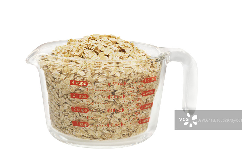 量杯中装满燕麦，工作室拍摄图片素材