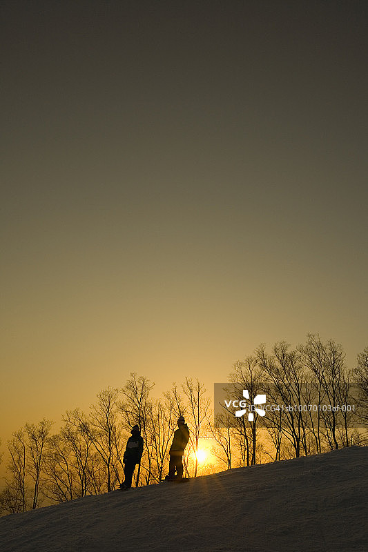两人在日落时分滑雪图片素材