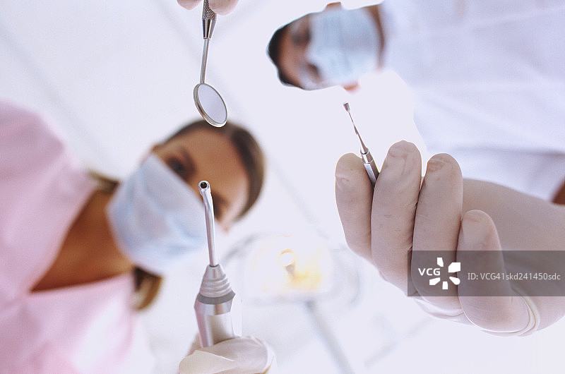 男牙医和女护士拿着牙科工具的俯视照片图片素材