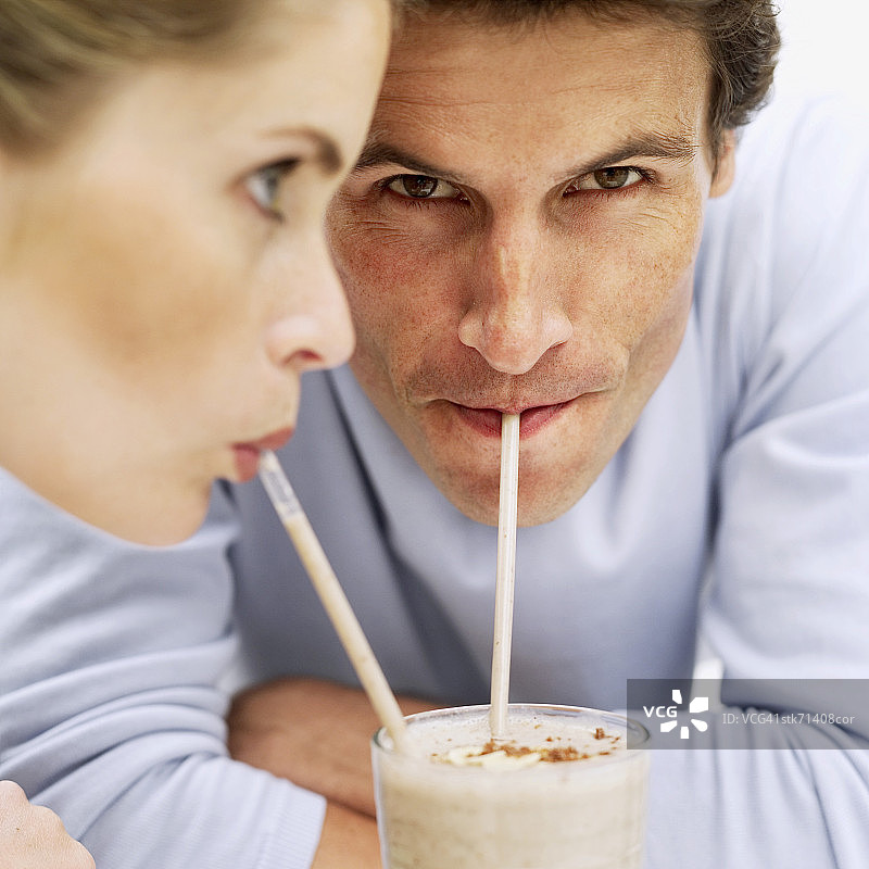 情侣用吸管分享奶昔图片素材