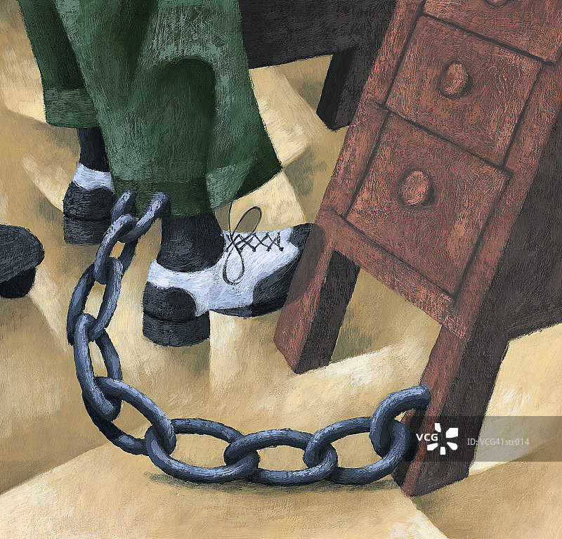男人被锁在办公桌旁图片素材