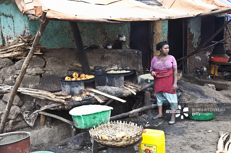 女人在建筑外烹饪，地点：埃塞俄比亚巴赫达尔塔纳湖，非洲图片素材