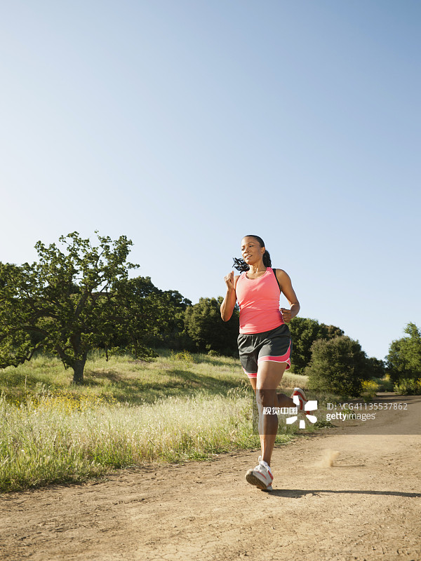 在偏远小路上跑步的黑人妇女图片素材