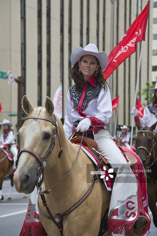 在卡尔加里牛仔节游行中骑马的女人，加拿大艾伯塔省图片素材