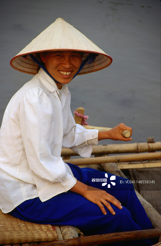 一位戴着锥形帽的友善女船夫在微笑图片素材