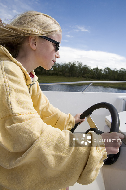 女孩在厄恩湖船屋上掌舵图片素材