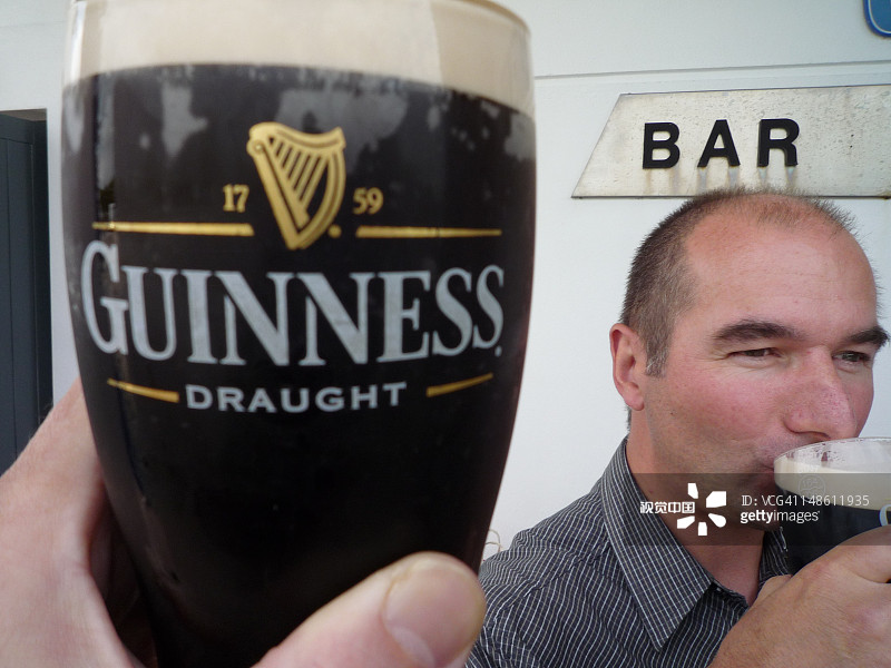 男子在凯里机场外喝健力士啤酒图片素材