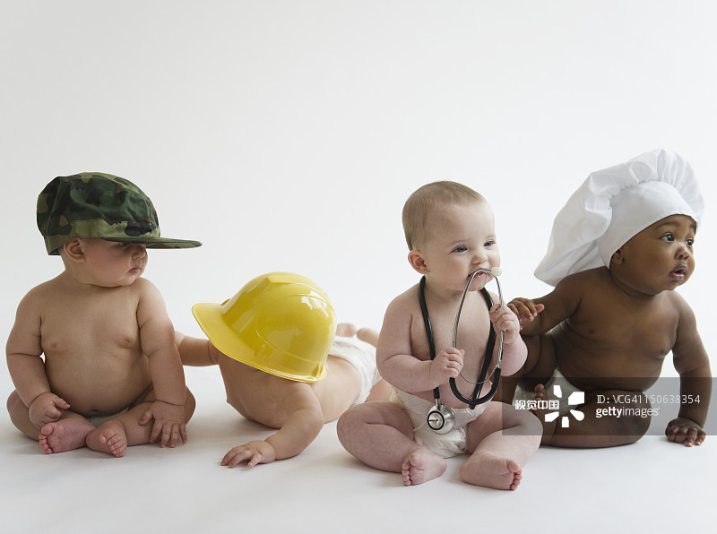 戴着职业帽的婴儿们一起坐在地板上图片素材