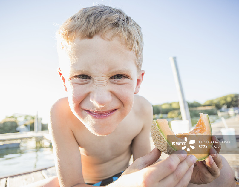 吃着哈密瓜的白人男孩图片素材