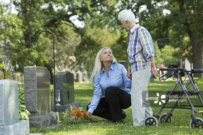 白人母亲和女儿在墓地扫墓图片素材