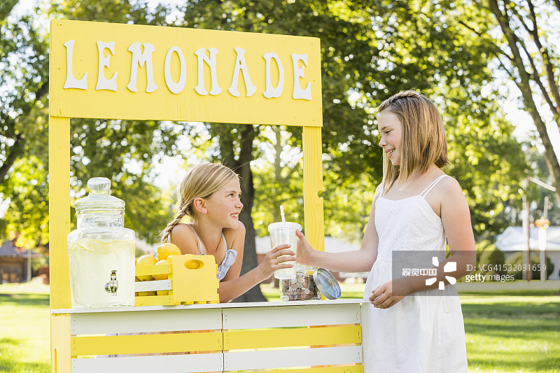 白人女孩在柠檬水摊位购买饮品图片素材