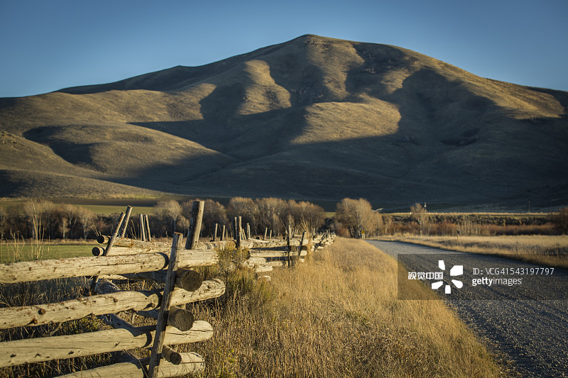 木栅栏和山区附近的田野图片素材