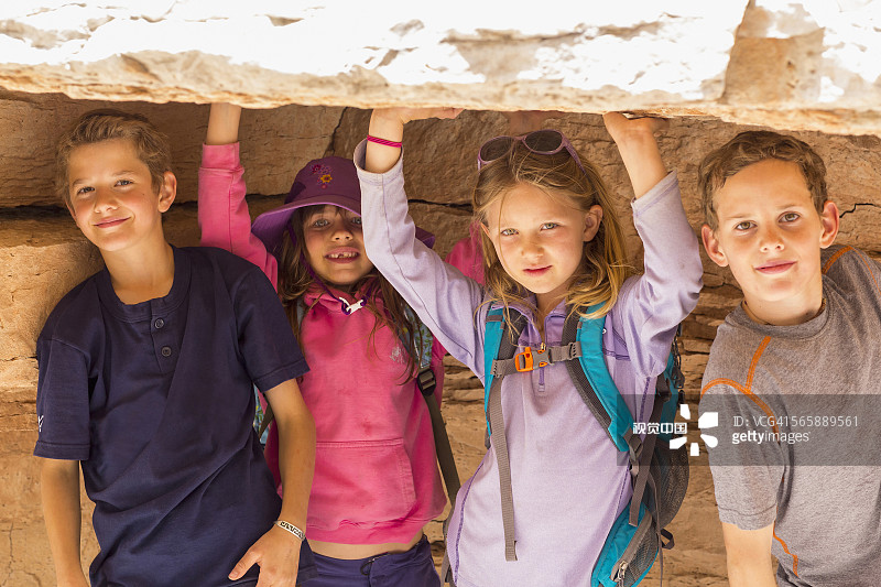 孩子们在岩层下蹲着图片素材