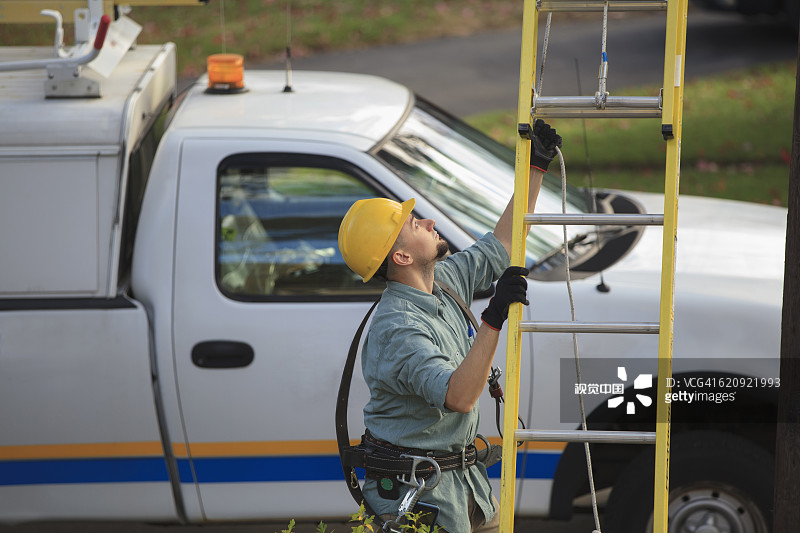 在户外扶梯子的白人职员图片素材
