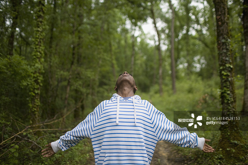 非洲男孩在森林里伸出了胳膊图片素材