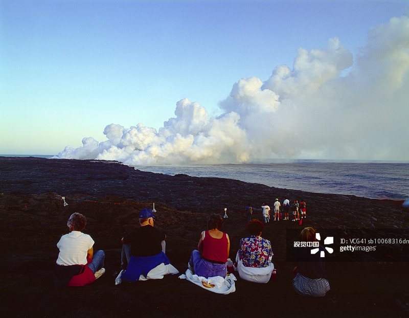 美国夏威夷大岛火山国家公园观看基拉韦厄火山爆发的人们（后视图）图片素材